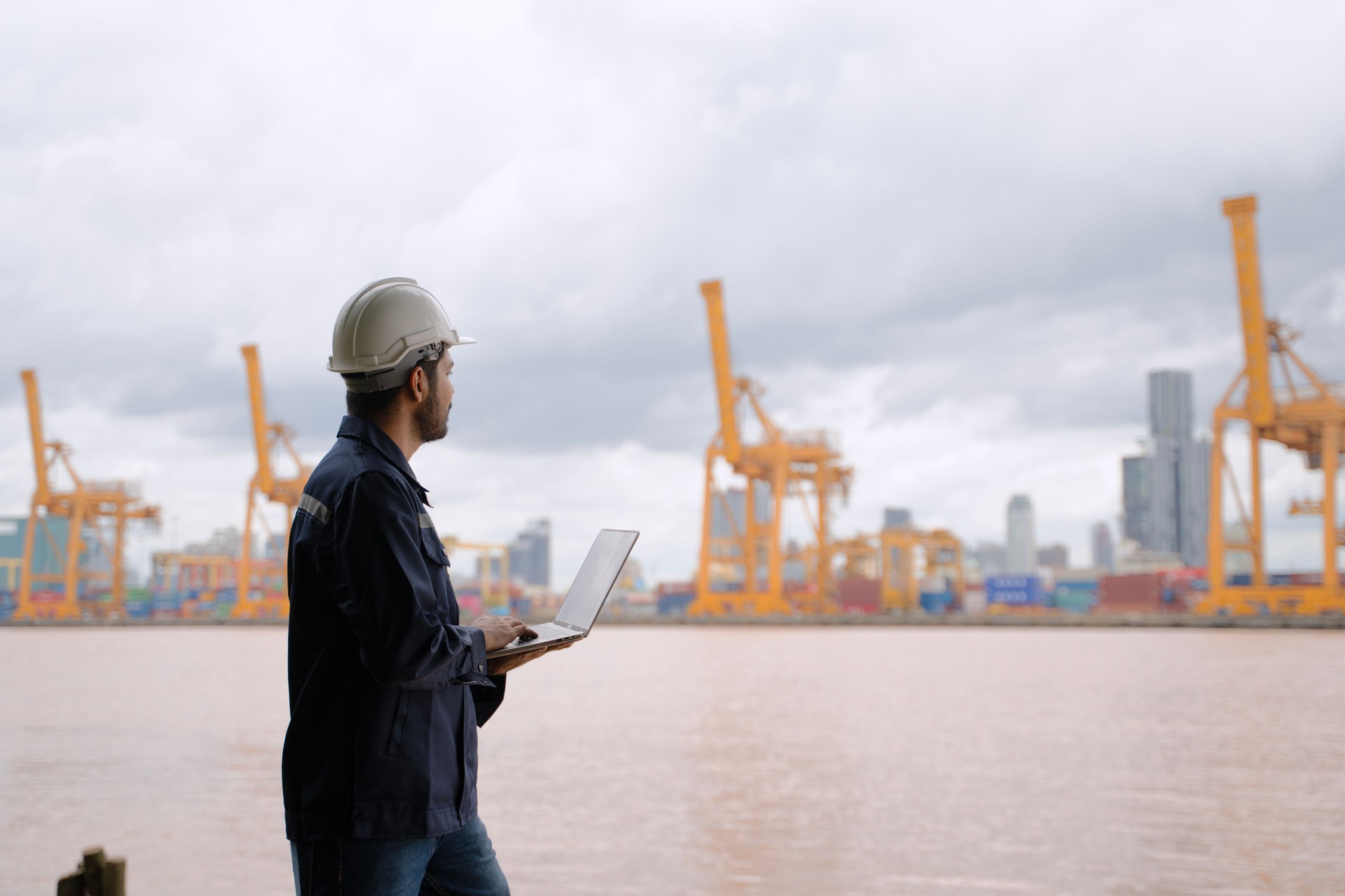 Seaport worker is working at waterfront.